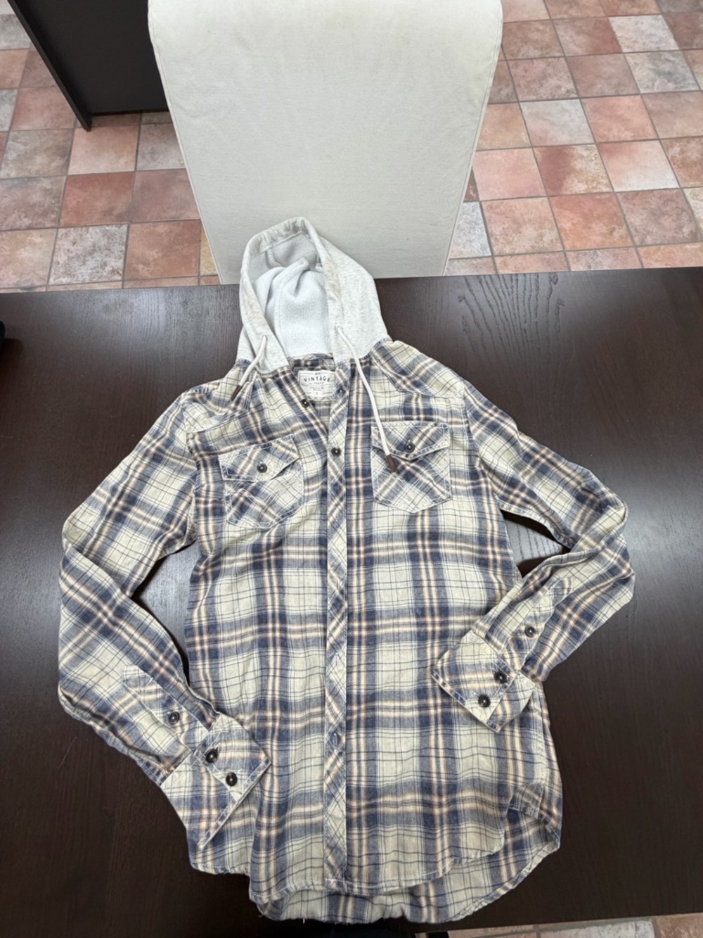 One small hooded button up long shirt

With small stains on the rim of the hood